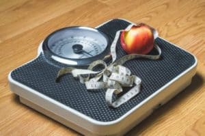 weight with measuring tape and apple on top