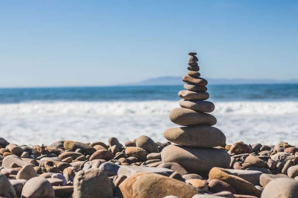 rocks topped on top of each other at the beach