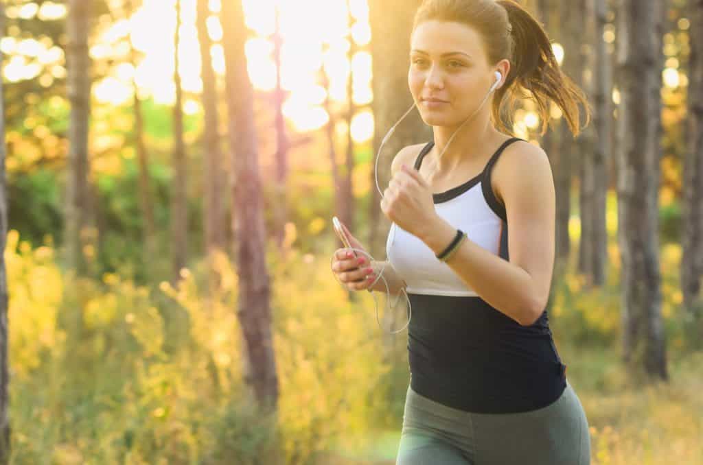 woman running with headphones trying to lose weight