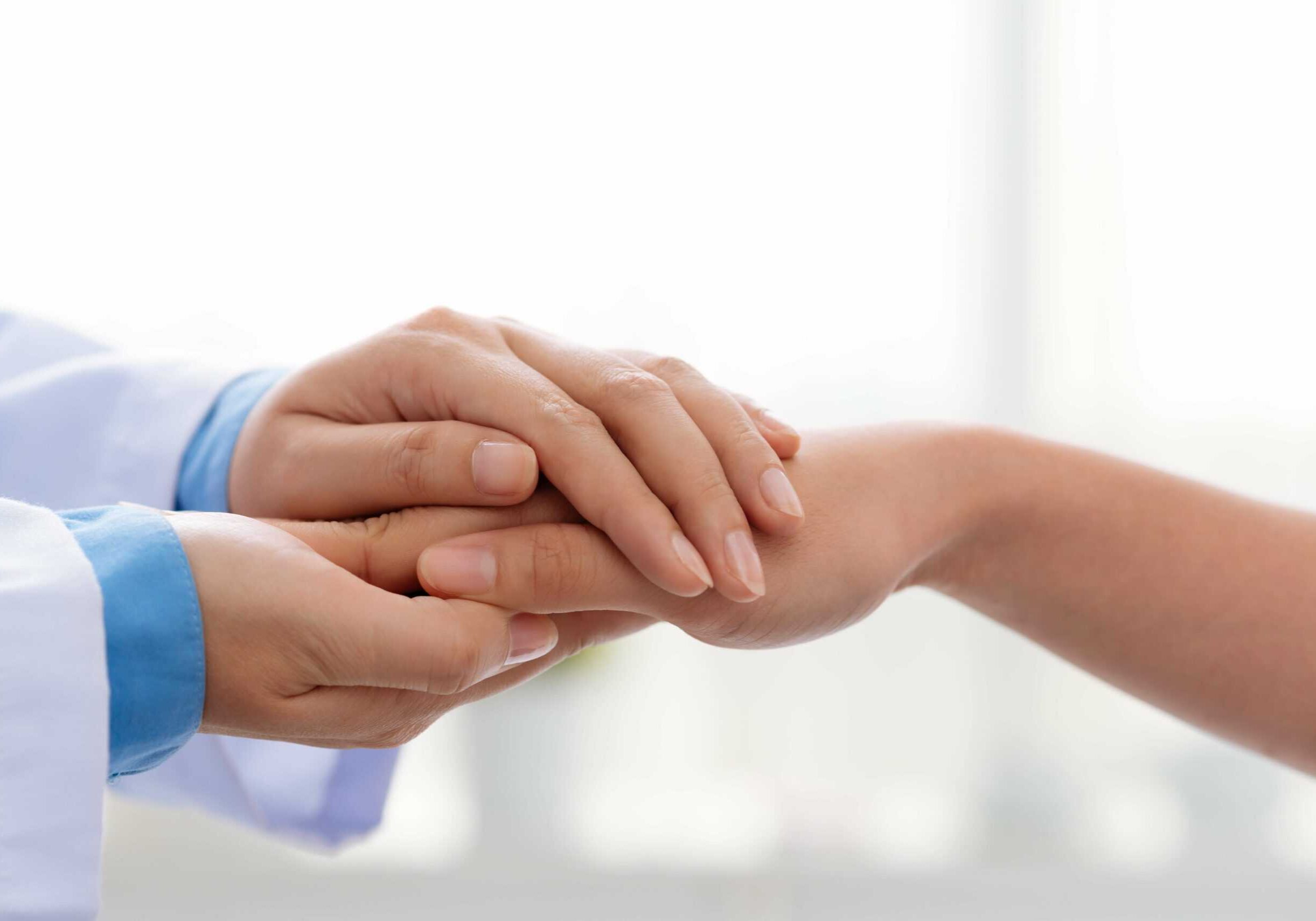 hand-of-doctor-reassuring-her-female-patient